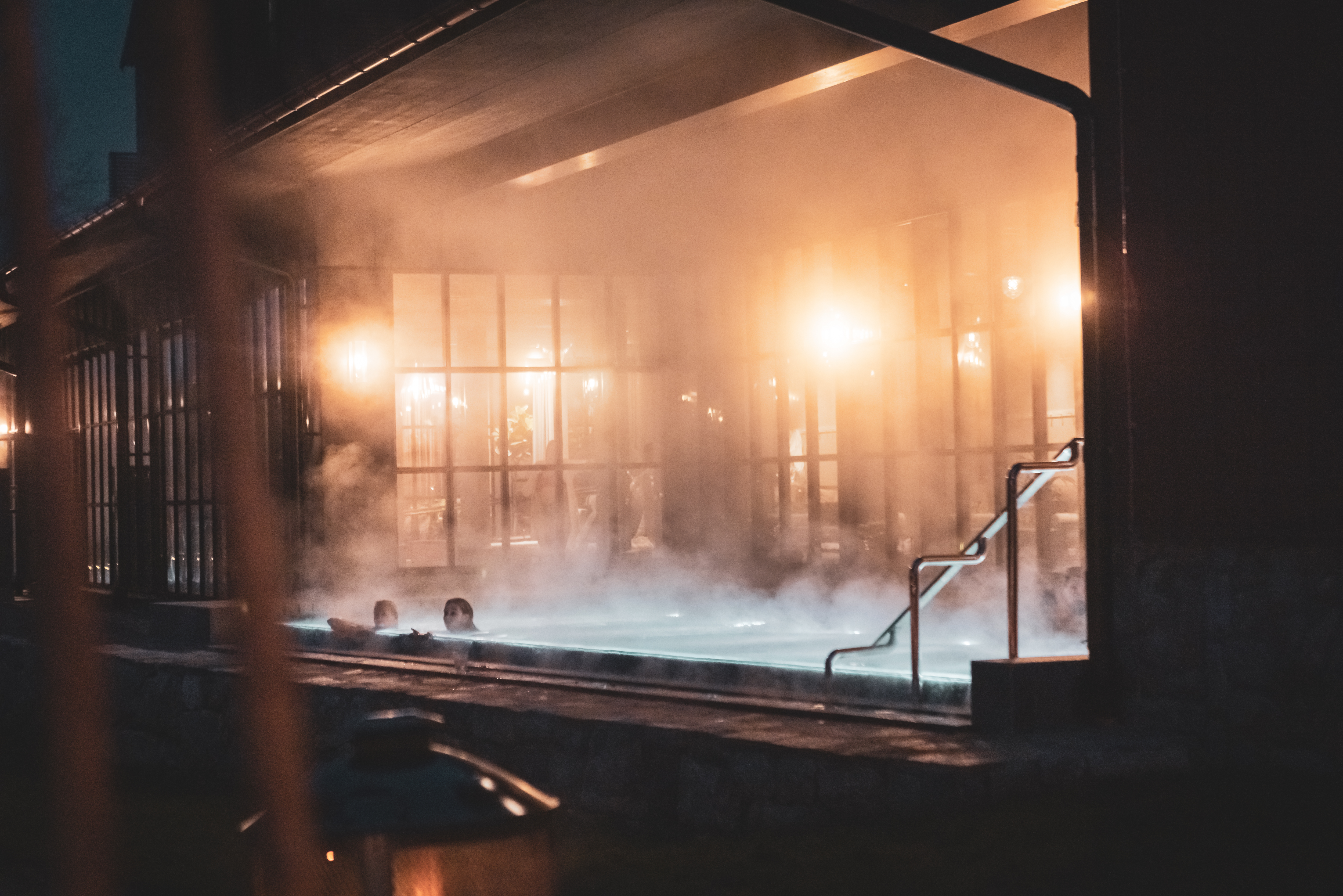 Ånga kommer från varm utomhuspool på vintern