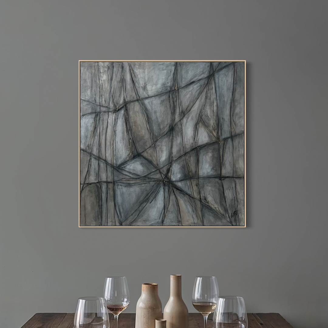 En tavla hänger över ett bord med vinglas