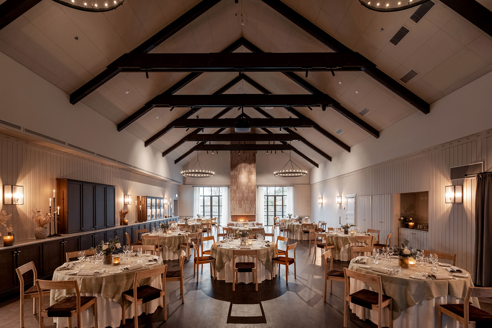 Rymlig festvåning dukad med små runda bord